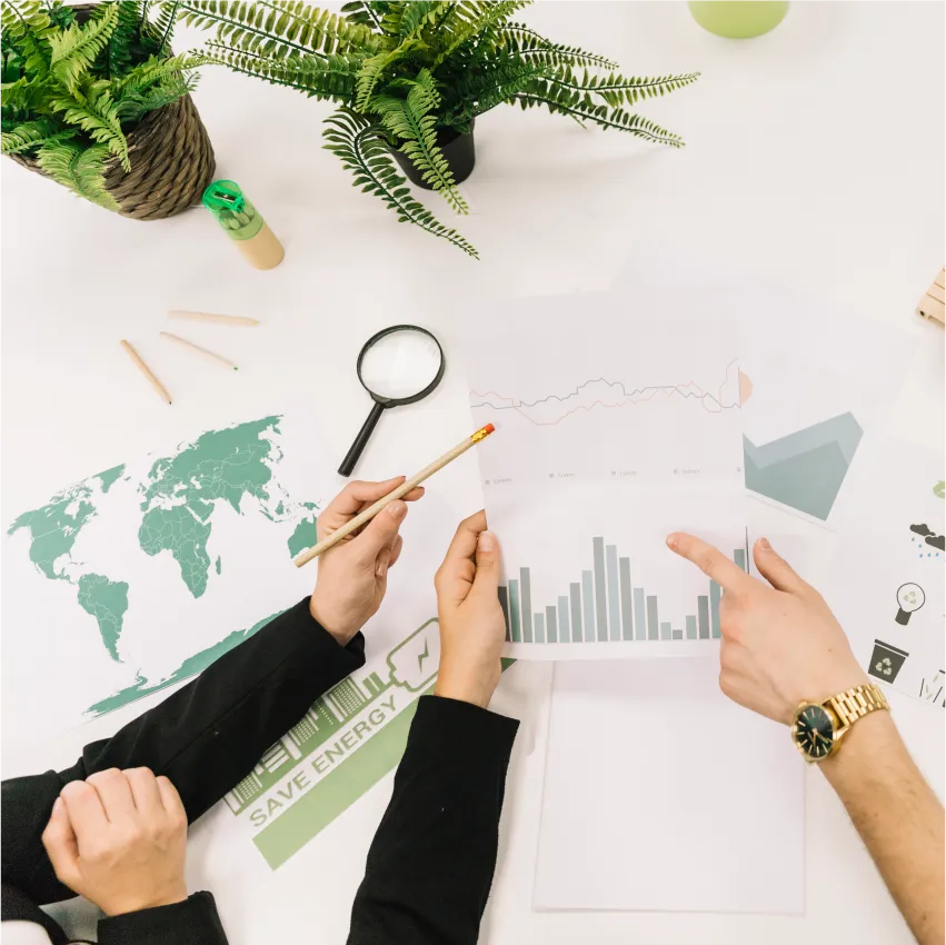 elevated-view-businesspeople-analyzing-graph-desk 1